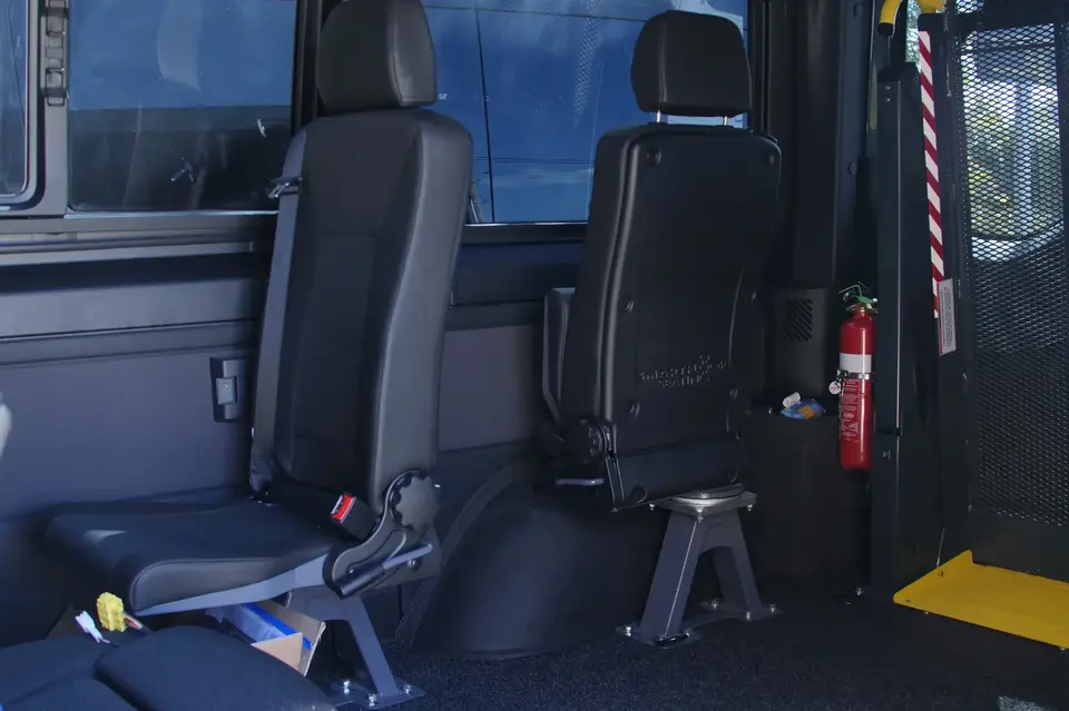 2 pivot seats in van, one folded and sideways, one unfolded facing front